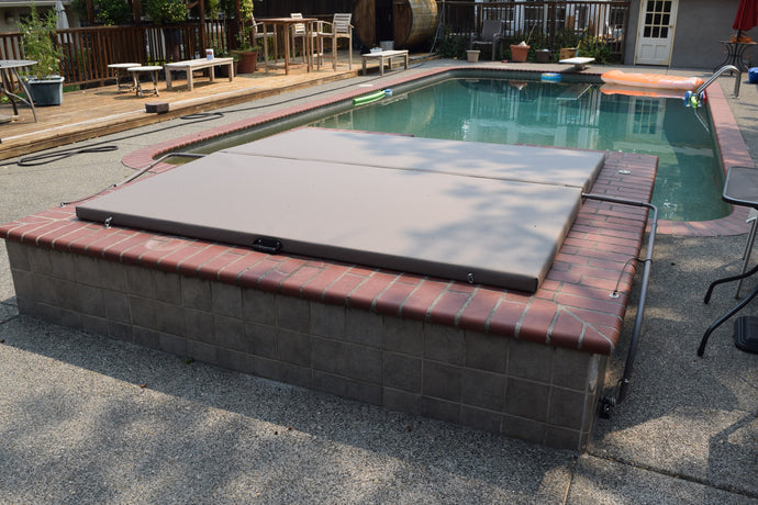 Brick edged spa with a mineral cover and lifter with extension