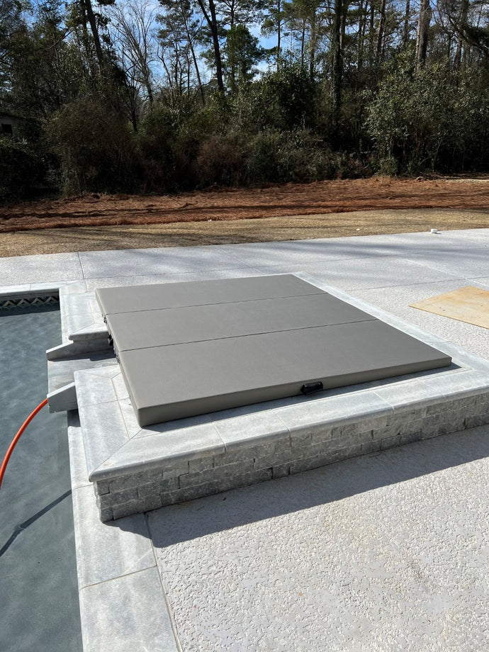 Three panel cover in mineral fabric on an in-ground spa