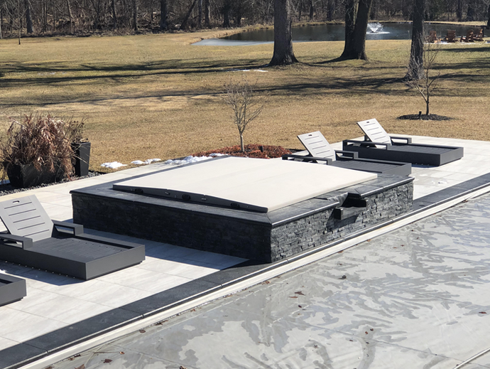 Three panel cover in mineral fabric on a raised in-ground spa