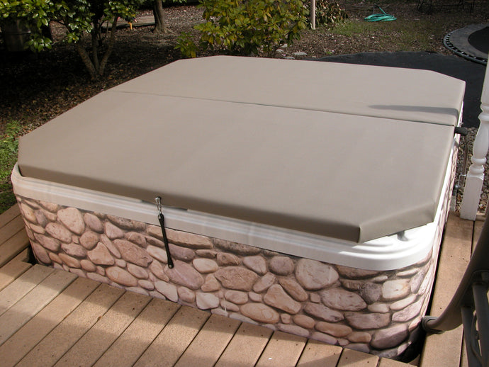 Mineral hot tub cover installed on a spa that is half in the deck