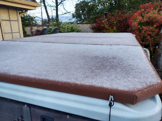 Snow layer on top of a cinnamon colored Airframe spa cover